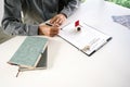 Close up businessman sign a contract, holding pen, sitting in office