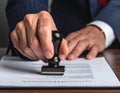 Businessman Signing Official Document with Stamp Royalty Free Stock Photo