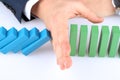 Close-up Of Businessman Stopping The Effect Of Domino With Hand Royalty Free Stock Photo