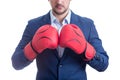 Close up businessman in suit with boxing gloves stands ready in a fighting stance, punching his fists. Business person self Royalty Free Stock Photo