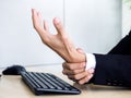 Young Asian businessman pain while using notebook computer in office Royalty Free Stock Photo