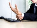 Young Asian businessman pain while using notebook computer in office Royalty Free Stock Photo