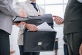 Close up. businessman taking out of his briefcase business documents.