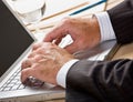 Close up of businessman typing on laptop