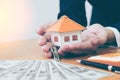 Businessman holding paper home model. Loan concept Royalty Free Stock Photo