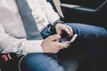 Close up of businessman using mobile smart phone in a car. Royalty Free Stock Photo