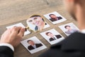 Businessman Viewing Candidates Through Magnifying Glass