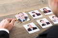 Businessman Viewing Candidates Through Magnifying Glass