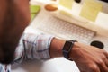 Close Up Of Businessman Wearing Smart Watch In Design Office