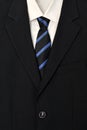 Close up of businessman wearing a tie, shirt, and suit.