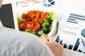 Close-up of businessman working on marketing strategy during business lunch. Royalty Free Stock Photo