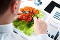 Close-up of businessman working on marketing strategy during business lunch. Royalty Free Stock Photo