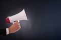 Close up of businessmans hand holding megaphone Royalty Free Stock Photo