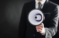 Close up of businessmans hand holding megaphone Royalty Free Stock Photo