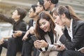 Close up of businessmen and businesswomen using smartphone