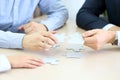 Close-up Of Businessmen Hand Connecting Jigsaw Puzzle
