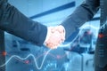 Close up of businessmen shaking hands with growing blue forex chart and index on blurry background. Trade, teamwork and financial Royalty Free Stock Photo