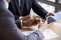 Close Up Of Businessmen Using Digital Tablet In Meeting