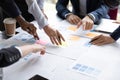 Close up of businesspeople discuss financial paperwork