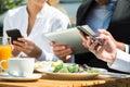 Close-up Of Businesspeople Using Digital Tablet And Mobile Phone