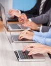 Close-up Of Businesspeople Using Laptop