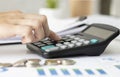 Close-up Of Busin Calculating Bills With Calculator In Office