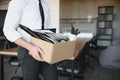 Close-up Of A Businessperson Carrying Cardboard Box During Office Meeting Royalty Free Stock Photo