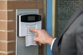 Close-up Of Businessperson Entering Code In Security System