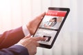 Close-up Of A Businessperson Holding Tablet