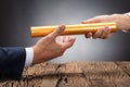 Close-up Of A Businessperson Passing Baton Royalty Free Stock Photo
