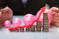 Close-up Of Businessperson Protecting Pink Piggy Bank