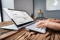 Businessperson Analyzing Invoice On Laptop Royalty Free Stock Photo