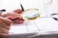 Businessperson Checking Bill With Magnifying Glass Royalty Free Stock Photo