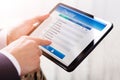 Businessperson Filling Checklist Form On Digital Tablet