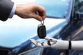 Businessperson Giving Car Key To Robot