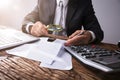 Businessperson Looking At Receipts Through Magnifying Glass Royalty Free Stock Photo