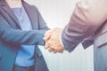 Close up businesswoman and businessman shaking hand for congratulation for success of business concept,Filter color effect. Royalty Free Stock Photo