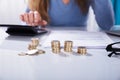 Woman Calculating Invoice With Stacked Of Golden Coins On Desk Royalty Free Stock Photo