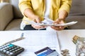 Close up of Businesswoman checking bills and calculating monthly expense at her desk. Home saving concept. Financial and Royalty Free Stock Photo