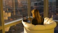 CLOSE UP: Businesswoman doing research on laptop while sitting in a sunlit room. Royalty Free Stock Photo