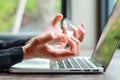 Close up businesswoman hand feeling exhausted from too much using computer Royalty Free Stock Photo