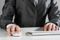 Closeup of businesswoman hand typing on keyboard with mouse on wood table Royalty Free Stock Photo