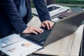 Close up businesswoman hand typing on laptop computer on table,working outside office with networking technology,tone filtered Royalty Free Stock Photo