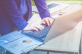 Close up businesswoman hand typing on laptop computer on table,working outside office with networking technology,tone filtered Royalty Free Stock Photo