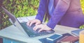 Close up businesswoman hand typing on laptop computer on table,working outside office with networking technology,tone filtered Royalty Free Stock Photo