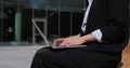 Close up of businesswoman hands using laptop outdoors near office building. Royalty Free Stock Photo