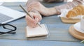 Close-up Of A Businesswoman Making Agenda On Personal Organizer At Workplace Royalty Free Stock Photo