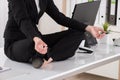 Businesswoman Meditating On Desk