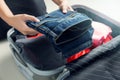 Close up of businesswoman packing clothes into travel bag Royalty Free Stock Photo