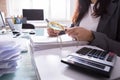 Businesswoman Checking Bill Through Magnifying Glass Royalty Free Stock Photo